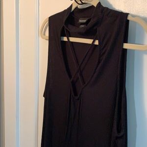 Black sleeveless top with criss cross front. NWOT